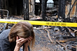 A woman is upset about her house which has burned down.