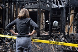 A woman is upset about her house which has burned down.