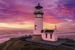 Coastal Lighthouse, inn keepers house and beautiful, colorful sunset sky.