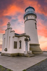 Coastal Lighthouse, inn keepers house and beautiful, colorful sunset sky.