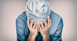 Crying doctor during COVID-19 needing help in hospital. Healthcare workers in despair over emergency need of PPE and distress. Coronavirus crisis death, dispair, mental health anxiety.