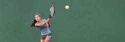 Tennis player playing game on outdoor hard court banner. Athlete Asian woman hitting ball with racket during match panoramic header. on green banner. Sports in competition.