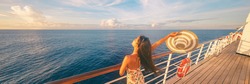Happy cruise woman relaxing on deck feeling free watching sunset from ship on Caribbean travel vacation. Panoramic banner of sea and boat.