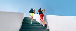 Stairs runners running up training hiit workout banner. Couple athletes sprinting uphill working out dynamic exercise panoramic.