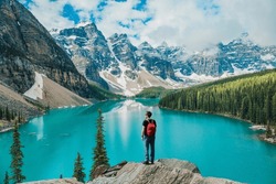 Canada travel man hiker at Moraine Lake Banff National Park, Alberta. Canadian rockies landscape people hiking with backpack lifestyle