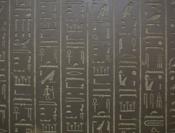 Ancient Egyptian hieroglyphs on a black stone