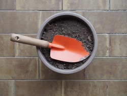 garden spade and bucket of earth for potted on terrazzo floor