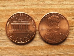 currency of the United States one dollar cent coin, obverse showing Lincoln portrait, reverse showing Lincoln memorial