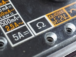 electrical symbols on a vintage analog multimeter measuring instrument