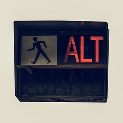 Vintage looking Traffic light for pedestrian crossing showing Alt sign in red meaning Stop