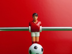 red on a red background foosball table soccer .sport teame football players
