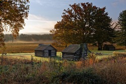 A misty morning at Valley Forge National Historic Park located in Valley Forge, Pennsylvania, USA. The buildings are reproductions of cabins used by Revolutionary War soldiers.