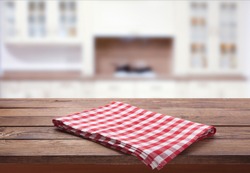 Kitchen towel on empty wooden table on white background. Napkin close up top view mock up for design. .