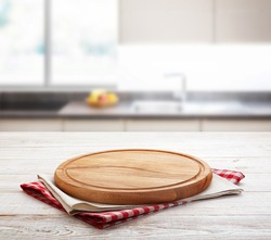 Napkin and board for pizza on wooden desk mockup perspective. Kitchen background selective focus.