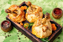 Chicken legs in pastry.Chicken leg in puff pastry on cutting board
