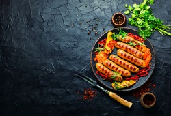 Appetizing grilled sausages with grilled vegetables. Sausages fried with pepper.