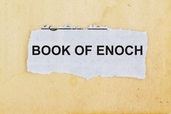 Book of enoch concept- newspaper cutout in an old paper background.