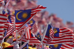 Crowd waving Malaysian flag