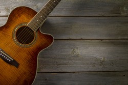 Acoustic guitar on wood background