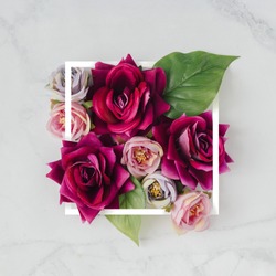 Creative layout made with flowers and white frame. Spring minimal concept. Nature background.