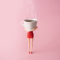 Girl in red dress holding big steaming cup of coffee against pastel pink background. Minimal coffee adiction concept. Poster advertisement