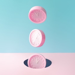 Pastel pink wall clocks on blue backdrop falling down. Time concept. Minimal composition.
