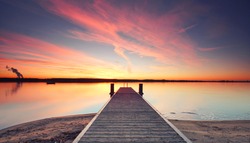 jetty sunset, wooden Pier on the lake, winter 