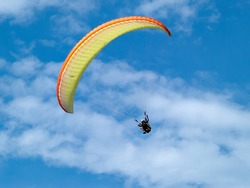 Paragliding in tandem against clear blue sky extreme sport background image