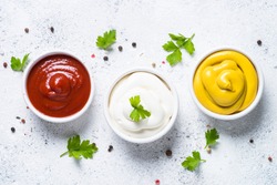 Set of sauces - ketchup, mayonnaise and mustard on white background. Top view.