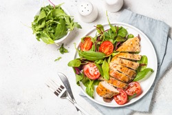 Chicken fillet with salad. Healthy food, keto diet, diet lunch concept. Top view on white background.