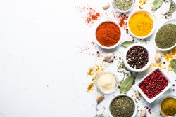 Set of various spices in a bowls on white background. Top view copy space.