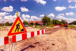 Work in progress, triangle sign with boundary, caution symbol, trench is on construction site. 