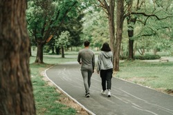 Sport couple walking on the path in the park