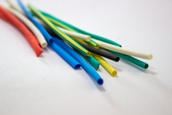 Heat-shrink tubing. Insulation for electrical wires. Plastic that shrinks with temperature. Tube for wire insulation.