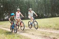 Sports family riding bicycles. Father, mother and son with bikes