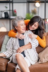 happiness asian family candid of daughter hug grandparent mother senior elder mom cozy relax on sofa couch in living room,Beautiful family of mother and daughter together, hugging and kissing at home