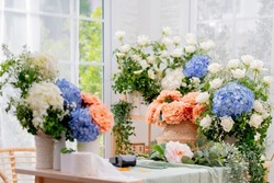 floral flower bouquet business shop,beaufiful fresh flower hydrangea white rose and natural basket arrange with order on table in flower small business shop morning light