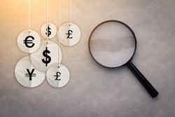 International economy icons under the magnifying glass business financial concept