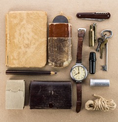 Old wrist watch,notebook,keys,tin spoon,a lighter and other miscellaneous items
