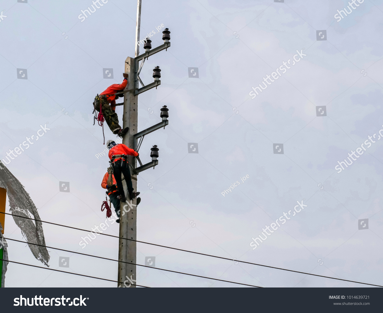 Electrical Engineers Working On Electricity Pylon Stock Photo