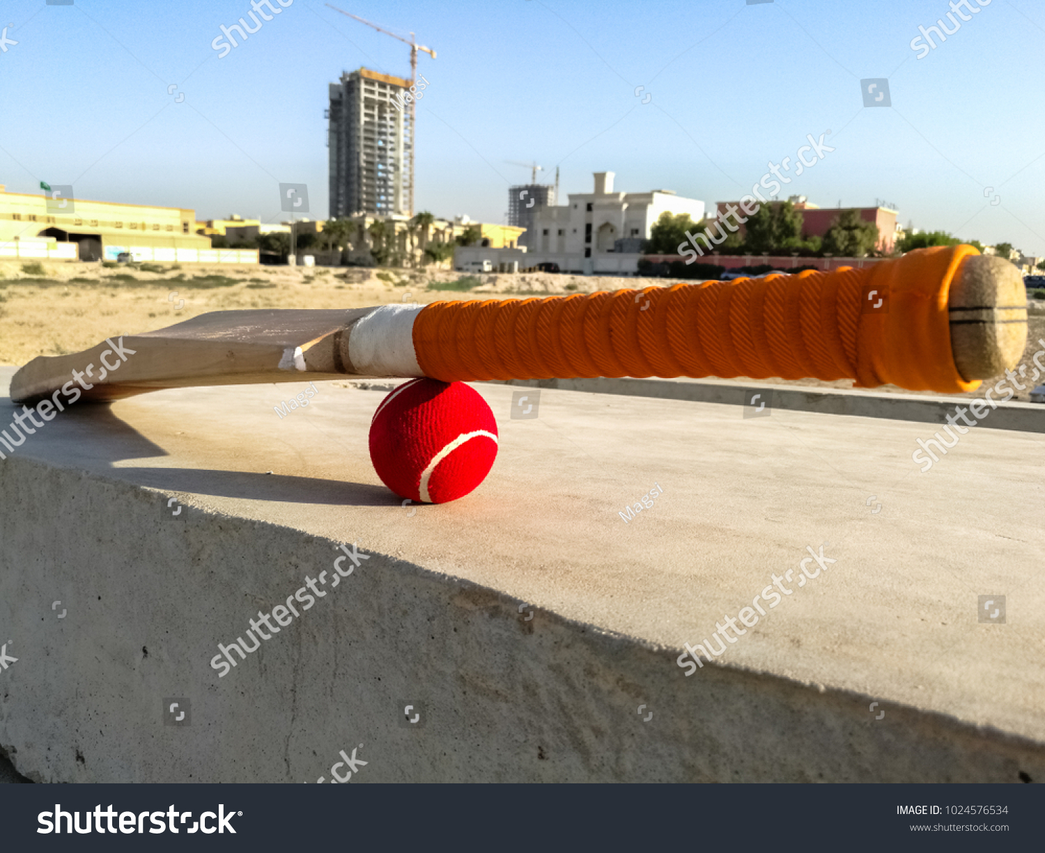 red tennis cricket bat