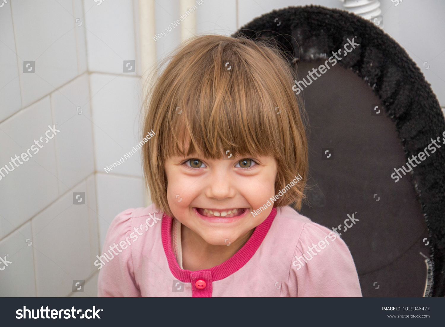 baby-girl-sitting-on-toilet-stock-photo-1029948427-shutterstock