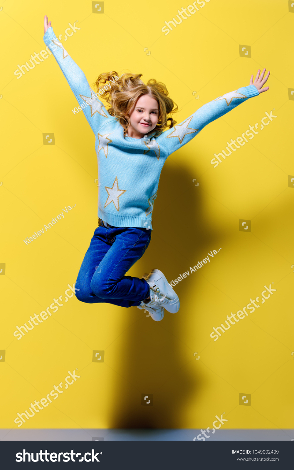 Joyful Preteen Girl Jumping Over Yellow Stock Photo 1049002409 ...