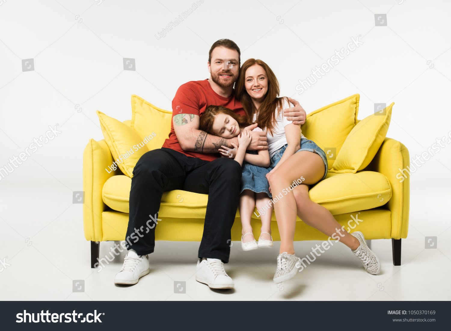 Happy Family Sitting On Couch Isolated Stock Photo 1050370169   Stock Photo Happy Family Sitting On Couch Isolated On White 1050370169 