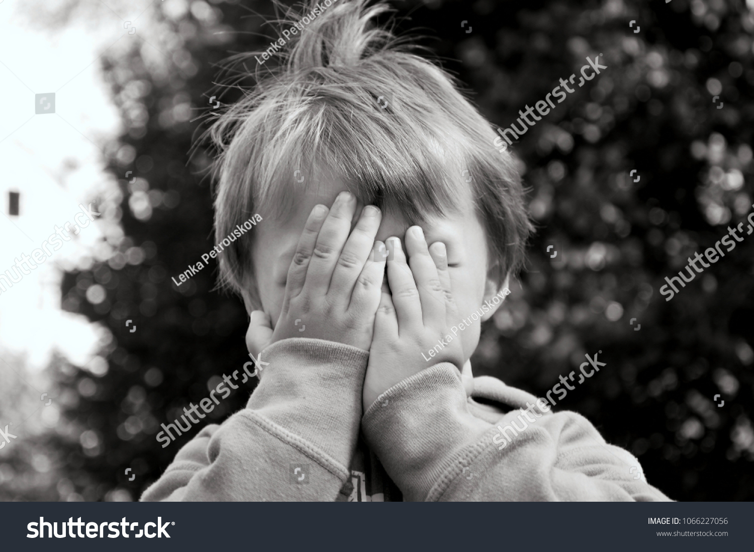 boy hiding his face