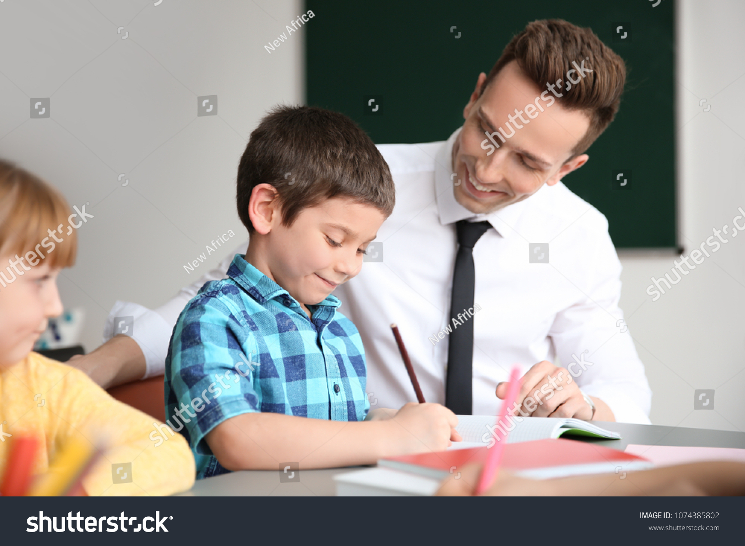 Male Teacher Helping Boy His Task Stock Photo 1074385802 | Shutterstock