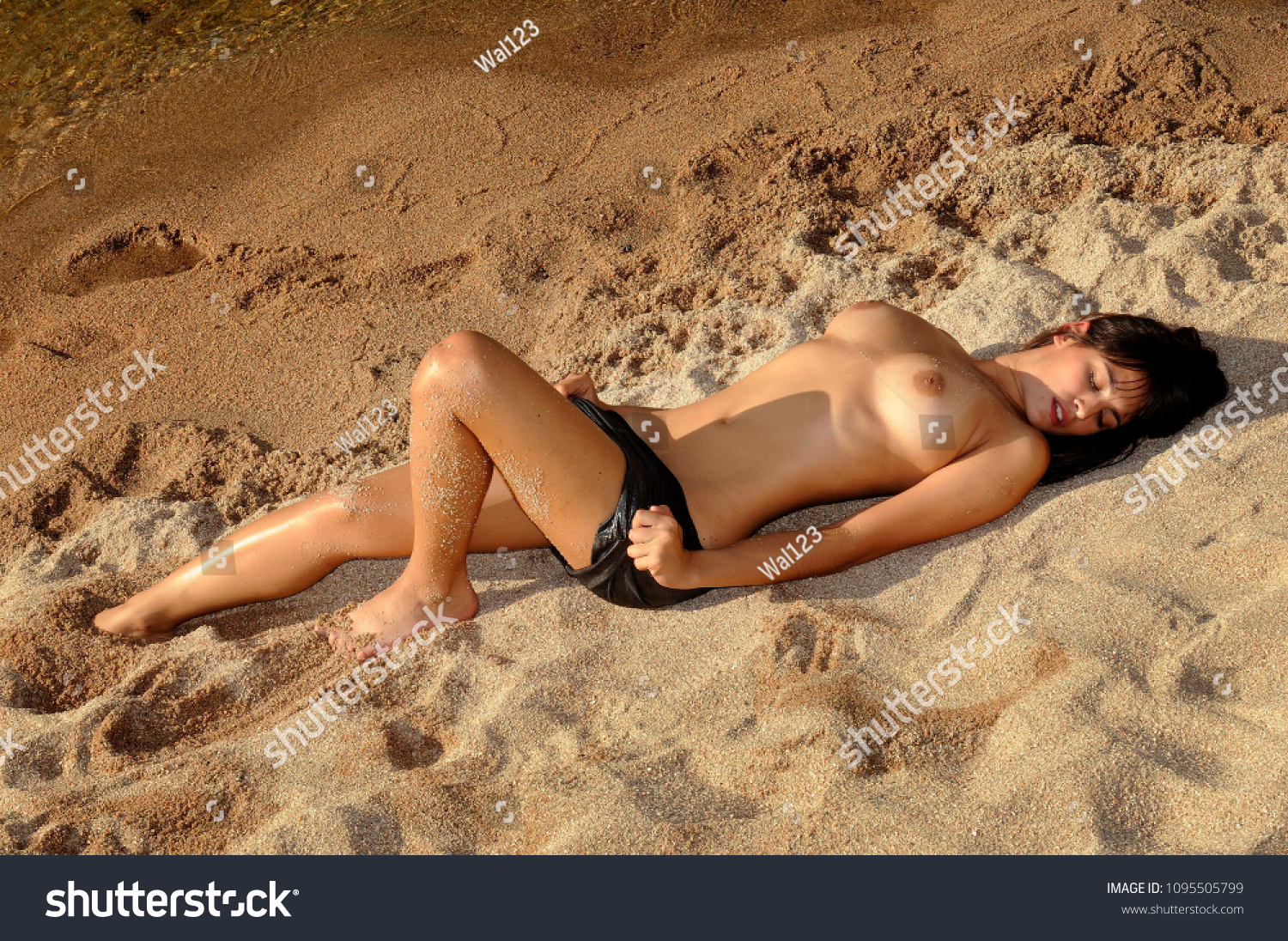 Beautiful Young Woman Lying On Beach