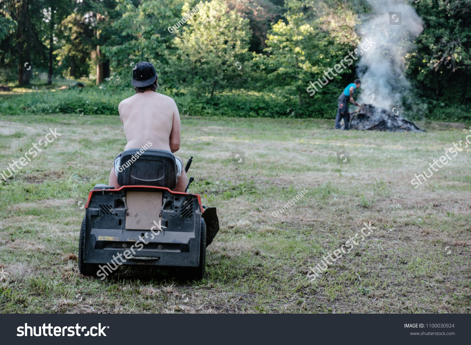 Naked Man Mowing The Lawn