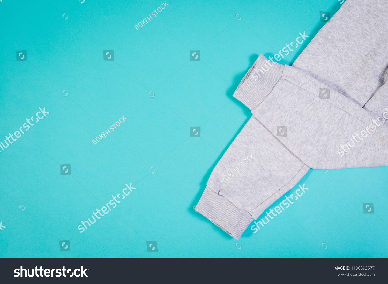 top-view-gray-sweatpants-on-turquoise-stock-photo-1100893577-shutterstock