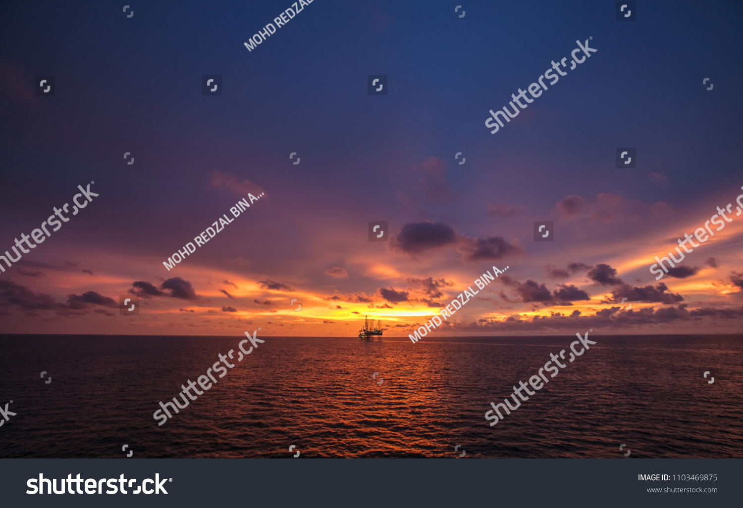 Silhouette Offshore Platform During Golden Hour Stock Photo